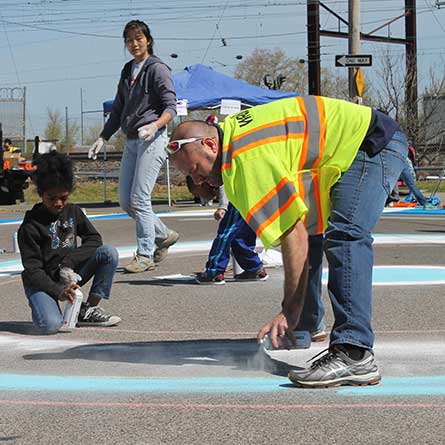 Artistic crosswalks and a roadway mural