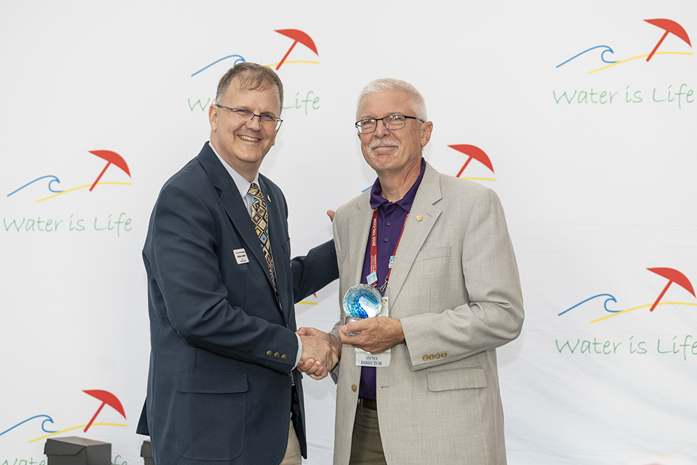 Andy Cooper holding award